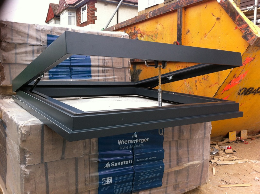Opening flat roof skylight in anthracite grey installed in Banstead
