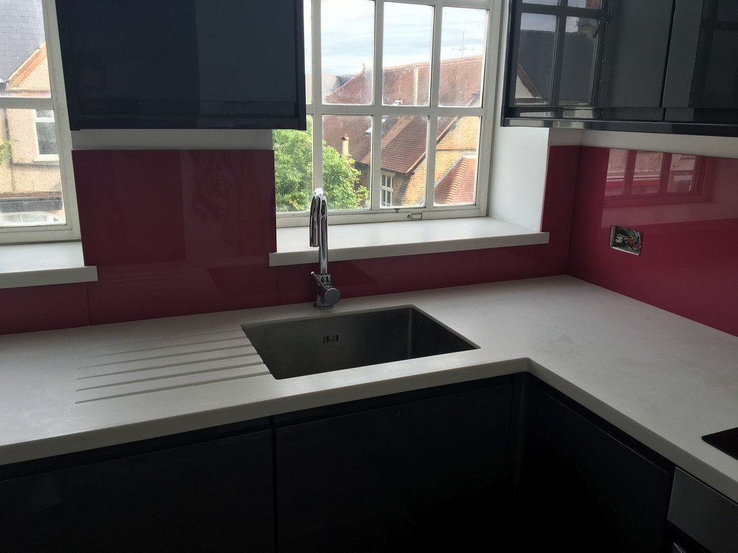 Deep plum coloured glass splashback in modern Banstead kitchen